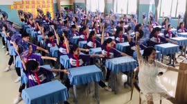 Chinese pupils perform dance routine with pregnant teacher during break