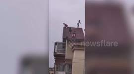 Chinese children captured playing on steep roof of high-rise building