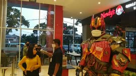 In Indonesia, a masked 'Transformer' educates shoppers on coronavirus