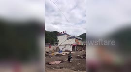 Hotel collapses into flooded river in southern China after rainstorm