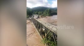 Bridge collapses into flooded river after heavy rain in Indonesia