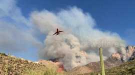 Wide-bodied DC-10 tanker flies extremely low over Catalina Mountain range to extinguish wildfire
