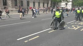Police officers on London's Whitehall carry Shields towards Parliament after clashes between officers and protesters when far-right demonstrations in London turned violent