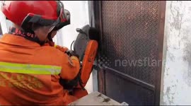 Firefighters cut free man trapped in boiling elevator in Indonesia