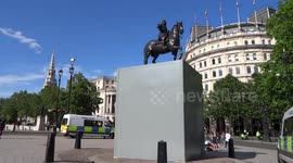 Construction workers fence the statue of Charles I in central London