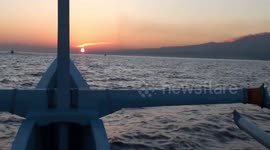 Dolphin watching at dawn off Lovina Beach, north coast of Bali, Indonesia.