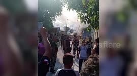 Military plane crashes into homes in Indonesia as pilot ejects