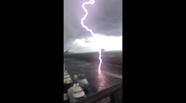 Lightning gives US filmer a fright as it strikes nearby river