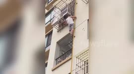 Retired Chinese soldier climbs four floors barehanded to rescue toddler hanging from window