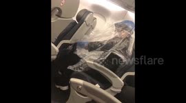 Woman flying to Chicago covers herself in plastic amid COVID-19