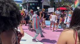 Protestors party at All Black Lives Matter Pride Rally in West Hollywood dancing to music in a dance circle on Santa Monica Boulevard