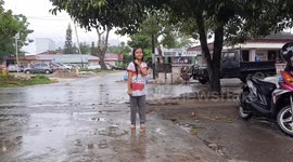 Indonesian girls dance in the rain