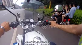 Police officer stops motorcycle with six people on it in China