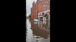 Beeston (Nottingham) flash flood traps car & damages local business & homes