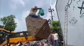 Indian politician and supporters deface billboard advertising Chinese products in Bihar