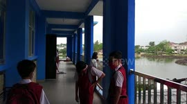 Students in Palembang, Indonesia continue to use standard health protocol tests