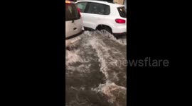 Vehicles drive through flooded streets as strong storm hits Belarus capital