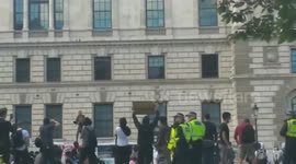 Woman seen standing on van with fist in the air driving alongside the Black Lives Matter protests in London
