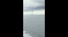 Large tornado passes between ships in Indonesia