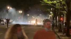 Tense scenes as anti-racism protesters in Portland shoot fireworks at police