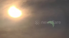 Solar eclipse with sun halo while raining