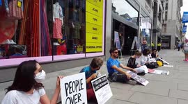 Extinction Rebellion protesters picket reopening clothing stores in London
