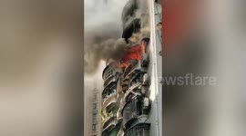 Residents move parked car to make way for fire engine attending blaze in southern China