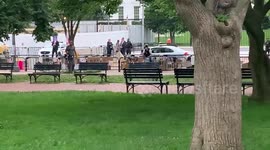 White House personnel outside and police stop protesters from taking down Andrew Jackson statue