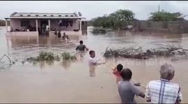 Western Indian villagers create human chain to rescue residents in flood