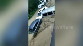 Floodwater washed away submerged cars in southern China