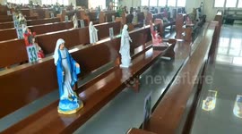 Church in the Philippines uses religious statues on benches to replace parishioners