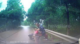Drunk motorcyclist crashes into oncoming car trying to overtake truck in China