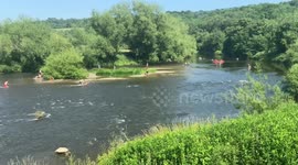 Britons cool off along the River Wye on hottest day of the year