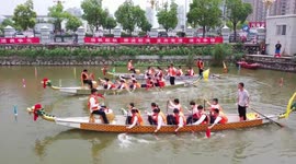 Schoolchildren take part in boat race during Dragon Boat Festival in China