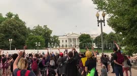 Black Lives Matter protesters wave to White House snipers