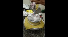 Talented baker pipes edible swans from whipped cream