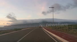 Very cloudy on top of the mountain, by the sea