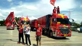 Liverpool fans in Thailand celebrate title victory with parade in red trucks