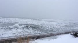 Heavy surf pound Massachusetts coastline during blizzard
