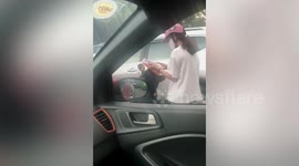 Student stuck in traffic jam on scooter does some last-minute revision