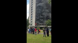Fire and smoke engulf London tower block as residents watch on