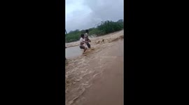 Heartstopping moment Indian villagers throw rope to save man drowning in flood