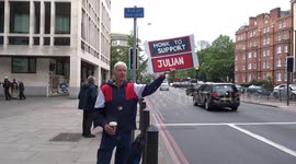 Protester with 'Honk to support Julian Assange' placard outside Westminster Magistrates Court on the day of court hearing