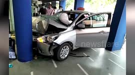 Pillar stops car crashing into shopfront in northern India