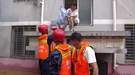 Chinese firefighters rescue residents trapped in flooded buildings after rainstorm