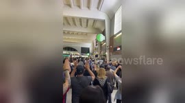 Parisian shoppers evacuated with hands above their heads after reports of gunman in the area