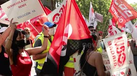 Rail workers protest mass job losses in front of Madrid train station