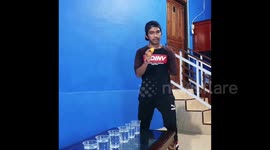 Demonstration of dexterity with the help of improvised means. The champion from Indonesia gets spheres in a glass of water without the help of hands