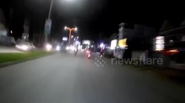 Police chase motorcycle rider and passenger waving a Samurai sword in Cambodia