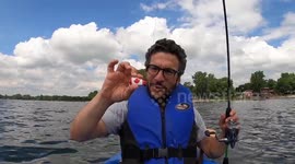 Canadian man catches fish while  whistling Canadian national anthem on Canada day